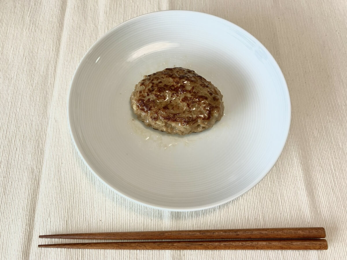 レンジで温めたコープデリのハンバーグをお皿に盛り付けた様子